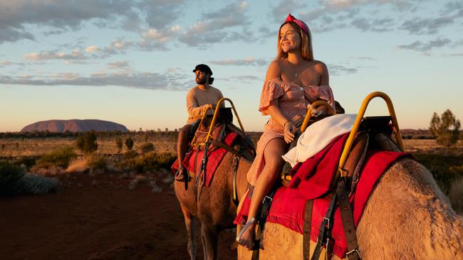 Territorians are about to have the chance to win $25,000 in prizes, simply by sharing their memorable Territory and Kimberley travel experiences – such as riding a camel at Uluru. Picture: Tourism NT/Matt Cherubino