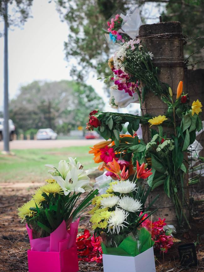 Floral tributes at the scene of a fatal two-vehicle collision on McMillans Road in Knuckeys Lagoon on Saturday. Picture GLENN CAMPBELL