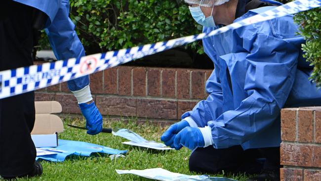 Police in the front yard of a Grange home where a man was stabbed in the chest in an early morning incident. Picture: Lyndon Mechielsen/Courier Mail