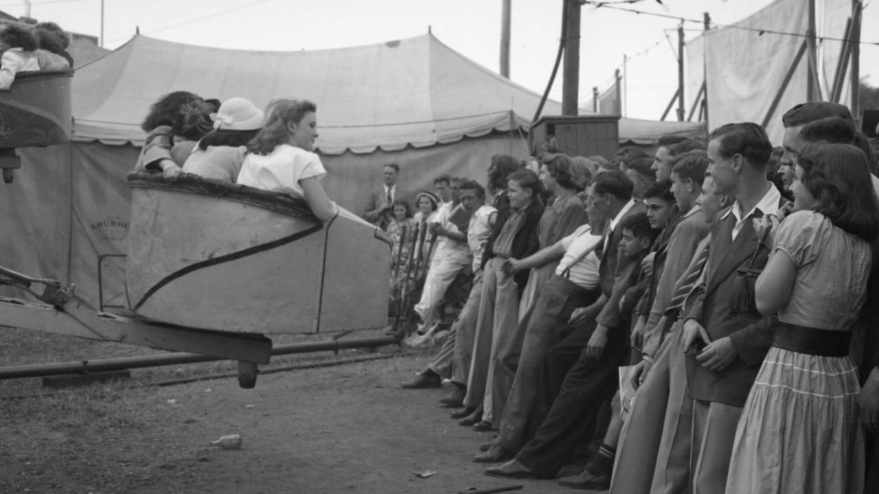 News 10/8/1949 People watching a ride at the R.N.A (EKKA) with more people waiting to get on .Neg no S253.Picture by.......The Courier-Mail Photo Archive.Scanned August 2012