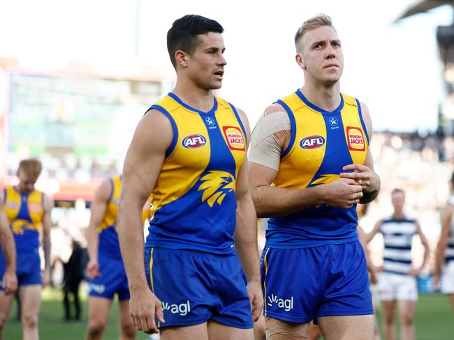 Liam Duggan and Oscar Allen of the Eagles lead the Eagles off after a demoralising loss on Saturday. Picture: Michael Willson/AFL Photos via Getty Images.