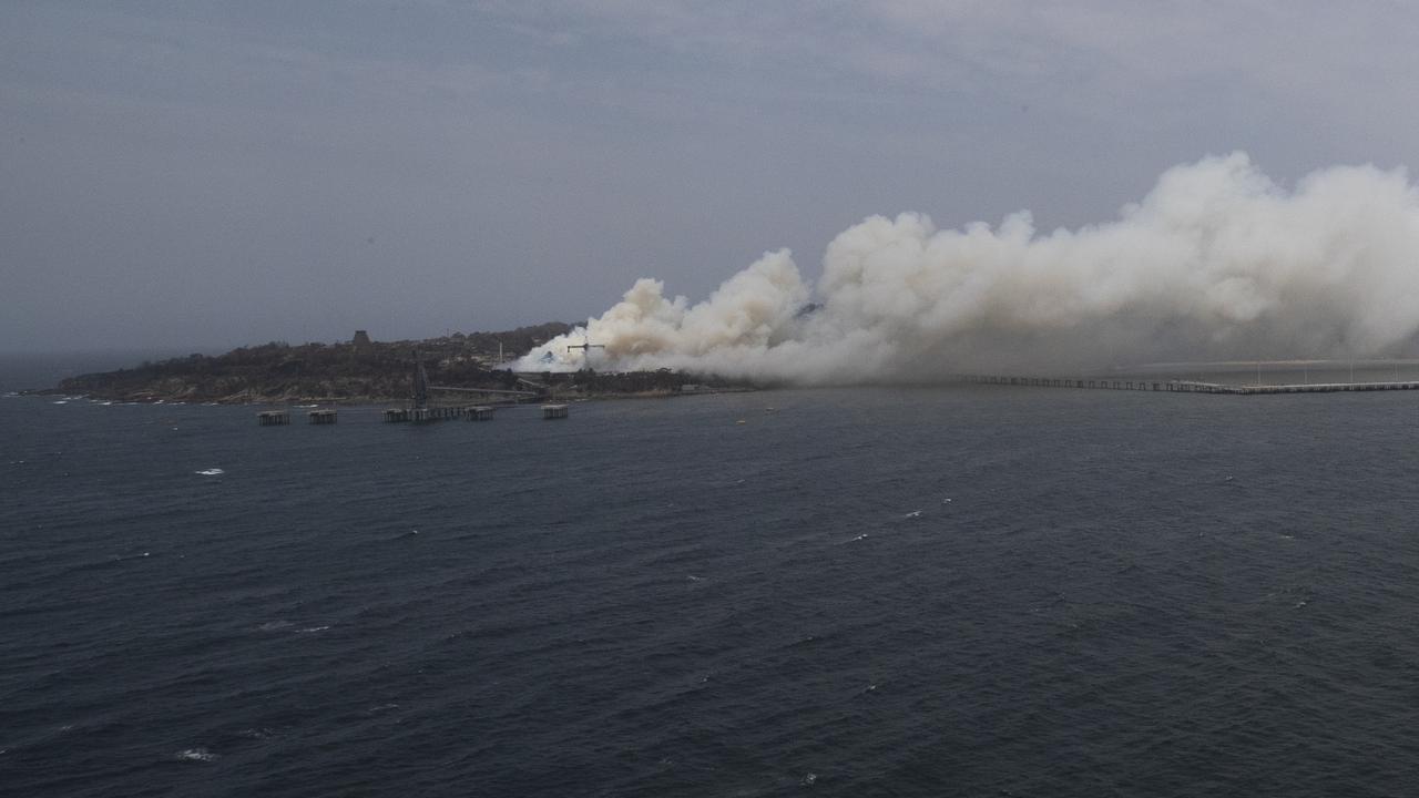 looking at the bushfires in Eden while onboard an MRH-90 helicopter during a visit to HMAS Adelaide for an update on defenceâ&#128;&#153;s assistance to the bushfire fighting and recovery efforts as part of Operation Bushfire Assist. *** Local Caption *** The Australian Defence Force (ADF) has commenced Operation Bushfire Assist 19-20 and has stood up Joint Task Forces in New South Wales and Victoria to enhance Defence support following devastating bushfires in the South East of Australia. ADF member are working side by side with emergency services personnel in the State Disaster Coordination Centre (SDCC) of the NSW Rural Fire Service Headquarters and alongside the Victorian Country Fire Service and Metropolitan Fire Brigades to provide best effect of ADF assets. HMAS Choules, MV Sycamore and Royal Australian Navy MRH-90 helicopters have conducted evacuations of people and animals from the fire-affected Victorian coastal town of Mallacoota. The Canberra Class Landing Helicopter Dock (LHD) HMAS Adelaide has also sailed from Sydney this afternoon to join the bushfire relief efforts and support the evacuation of people from fire-affected communities. The ADF is also providing transport and other assistance such as aviation ground support, logistics, engineering and accommodation support to the firefighting effort.