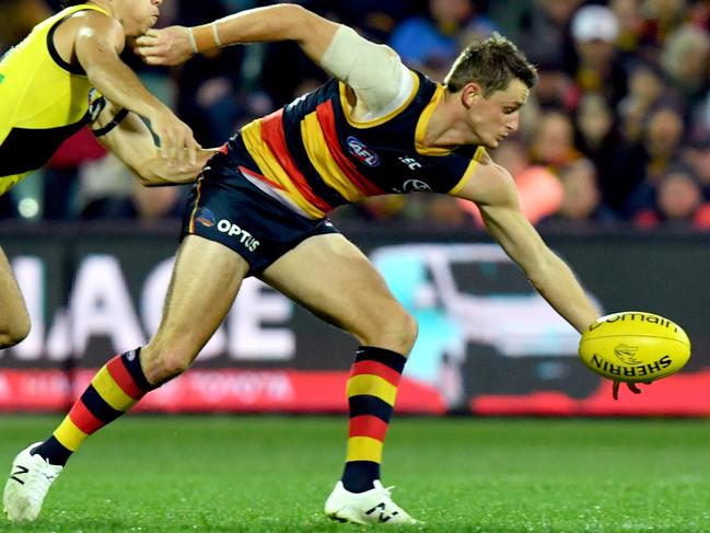 Crows Matt Crouch reaches for the ball ahead Tiger Daniel Rioli on his way to picking up 35 disposals in Adelaide’s 33-point win at Adelaide Oval. Picture: AAP Image/Sam Wundke