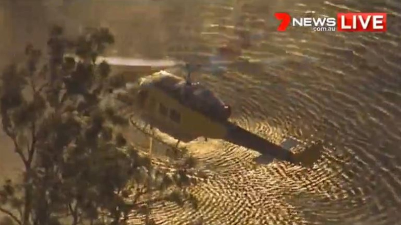 A water bombing helicopter responded to a bushfire burning in Narangba. Picture: 7 News