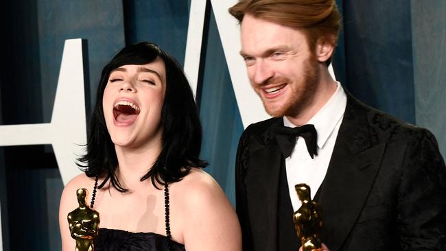 Billie Eilish and Finneas O'Connell hold the award for Best Music (Original Song) for No Time to Die at the Oscars. (Photo by Patrick T. FALLON / AFP)