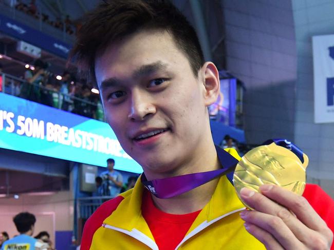 TOPSHOT - China's Sun Yang poses with his gold medal after the final of the men's 200m freestyle event during the swimming competition at the 2019 World Championships at Nambu University Municipal Aquatics Center in Gwangju, South Korea, on July 23, 2019. (Photo by Ed JONES / AFP)