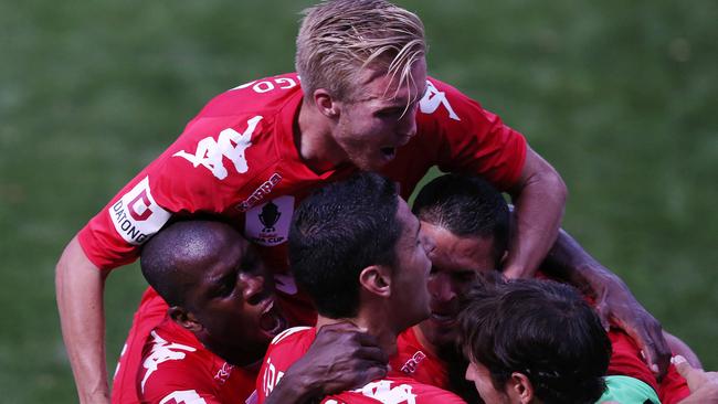 Sergio Cirio is mobbed by teammates after his goal.