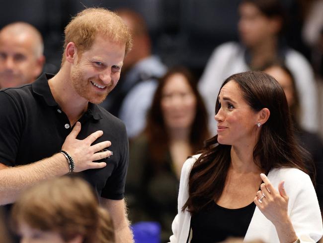 Meghan Markle and Prince Harry today laughed with Invictus Games crowds as they watched the wheelchair basketball in Germany.