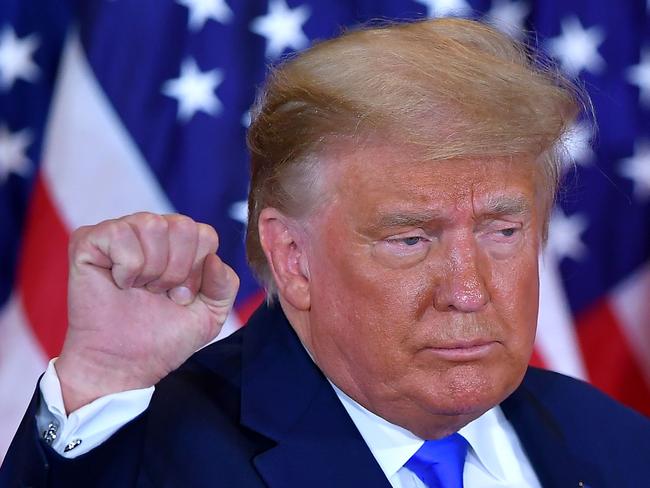 US President Donald Trump pumps his fist after speaking during election night in the East Room of the White House in Washington, DC, early on November 4, 2020. (Photo by MANDEL NGAN / AFP)