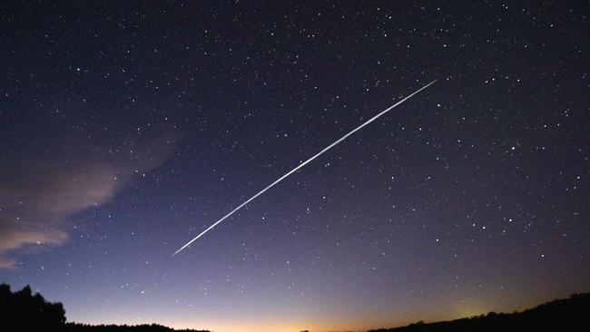 This long-exposure image shows a trail of a group of SpaceX's Starlink satellites passing over Uruguay as seen from the countryside n February 2021. Picture: Mariana SUAREZ / AFP