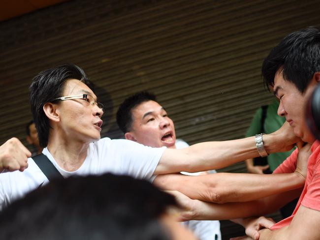 Pro-Beijing supporters confront a man in the Sham Shui Po area of Hong Kong. Picture: AFP