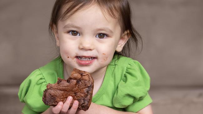 Isabella, 2, liked the chocolate flavoured Hot Cross buns. Picture: Kelly Barnes