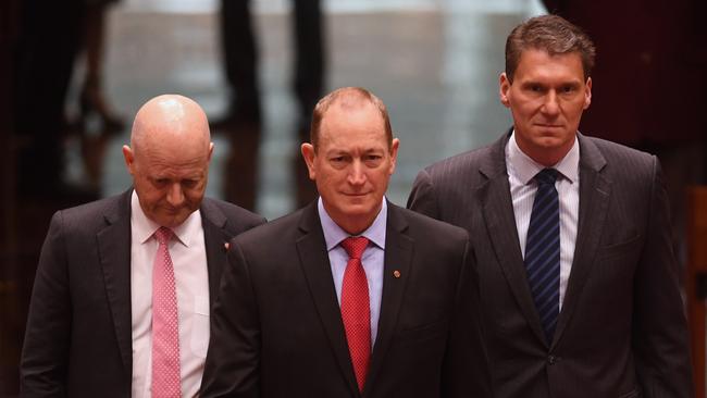 Fraser Anning, centre, is led into the Senate by David Leyonhjelm, left, and Cory Bernardi after his One Nation defection. Picture: AAP