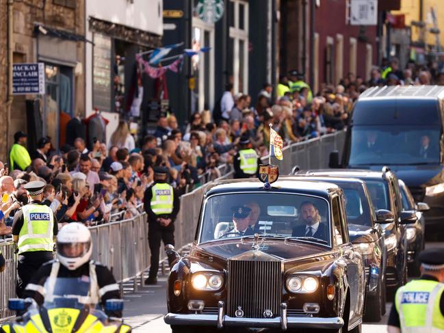 Britain's King Charles III and Britain's Camilla, Queen Consort are driven along the Royal Mile towards the Palace of Holyroodhouse, in Edinburgh on September 12. Picture: Odd Andersen / AFP