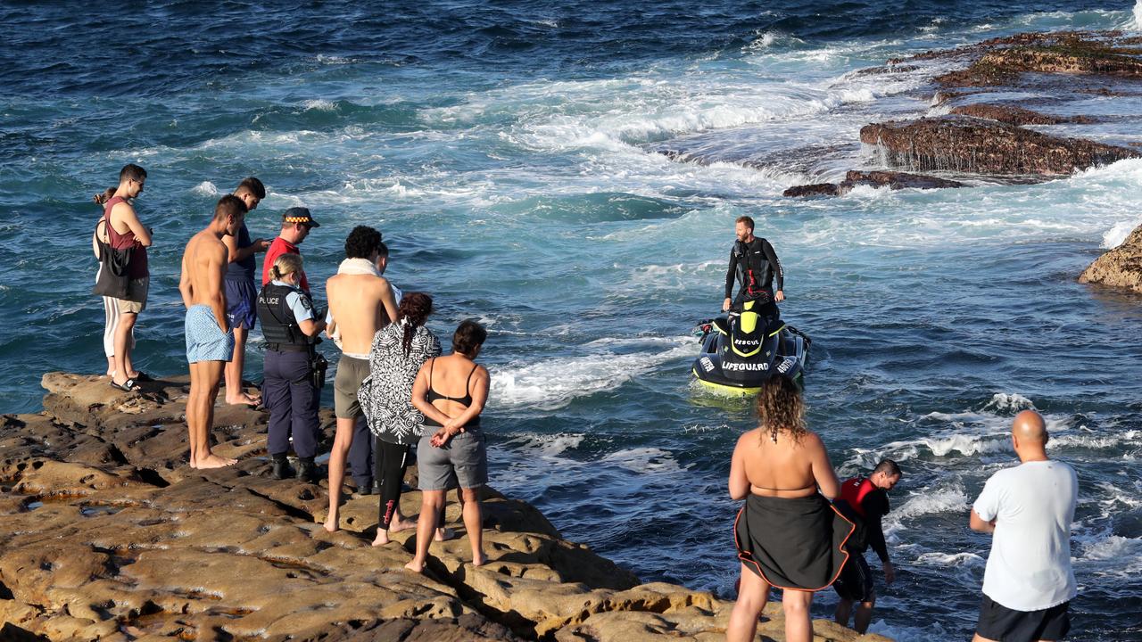 Locals and police at Little Bay on Wednesday. Picture: Richard Dobson