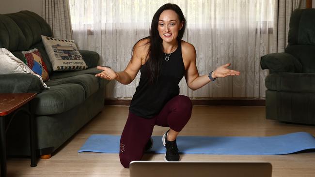 Kylie Simpson shows her set-up for online exercise and tumbling classes she holds in her parents’ South Penrith loungeroom. Picture: John Appleyard