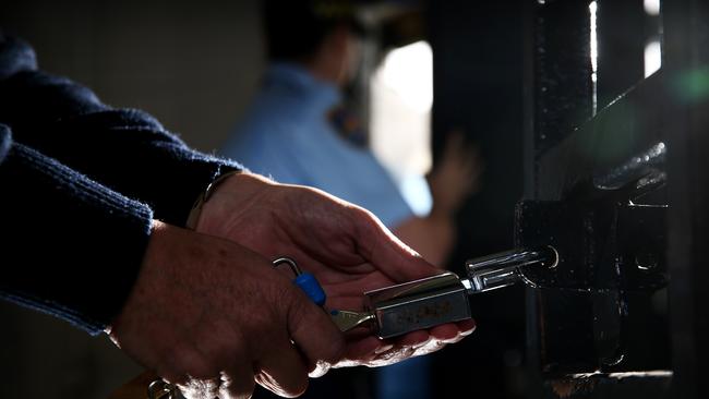 SUNDAY TELEGRAPH ONLY - Generic photo of hands opening a lock on a prison cell gate, at the Brush Farm Corrective Services training headquarters in Eastwood today. Picture: Tim Hunter.