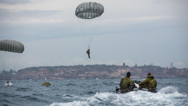 Australian Army soldiers from Special Operations Training and Education Centre parachute into the waters off Manly, Sydney, during a training activity. Picture: Department of Defence