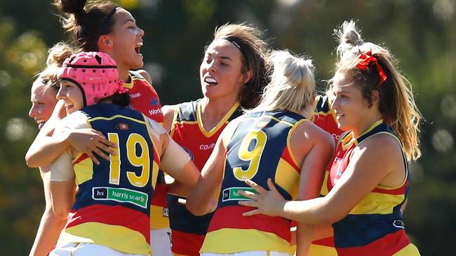 Crows players celebrate as the final siren sounds against Collingwood.