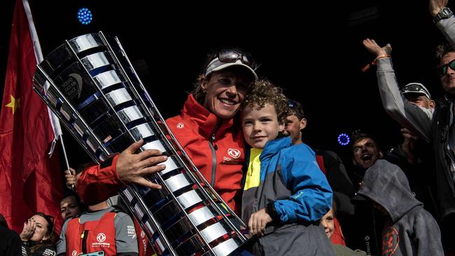 Dutch Trimmer Carolijn Brouwer of Dongfeng Race Team of China, celebrates with her son Kyle after winning the Volvo Ocean Race in Scheveningen. / AFP PHOTO / Christophe ARCHAMBAULT