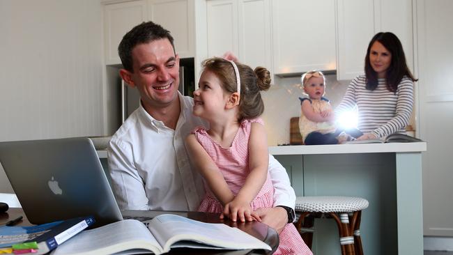 David Morgan gets help from daughter Olivia while doing his homework. Pics Adam Head