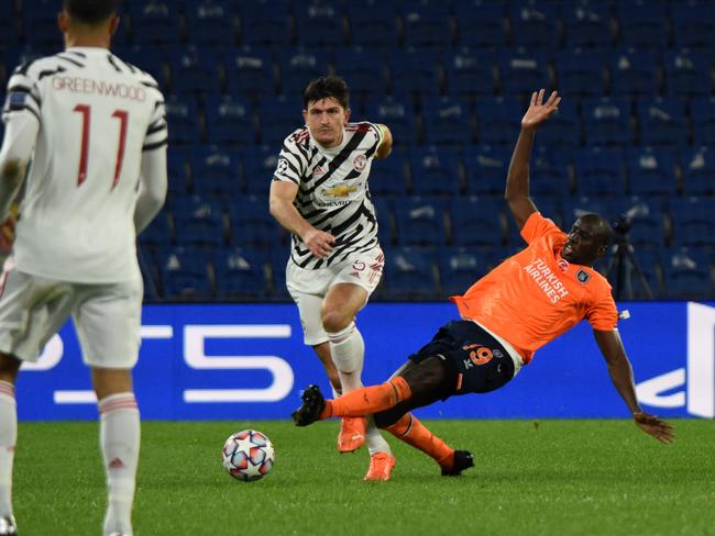 ISTANBUL, TURKEY - NOVEMBER 04: Harry Maguire of Manchester United is challenged by Demba Ba of Istanbul Basaksehir FK during the UEFA Champions League Group H stage match between Istanbul Basaksehir and Manchester United at Basaksehir Fatih Terim Stadyumu on November 04, 2020 in Istanbul, Turkey. Sporting stadiums around Turkey remain under strict restrictions due to the Coronavirus Pandemic as Government social distancing laws prohibit fans inside venues resulting in games being played behind closed doors. (Photo by Burak Kara/Getty Images)