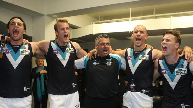 AFL football – Adelaide Crows vs Port Adelaide Power Showdown 28 match at AAMI stadium – Coach Mark Williams (c) with (l-r) footballer Troy Chaplin, Dean Brogan, Warren Tredrea and Jason Davenport celebrating after the game, singing the club song.