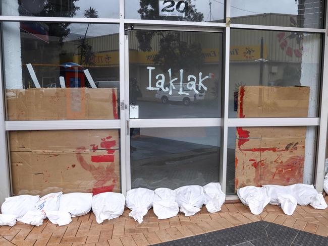 A row of sandbags cover the front of a shop in the town of Lismore. Picture: David Gray/AFP)