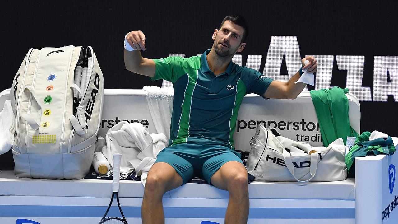 Novak Djokovic pretends to conduct the crowd booing him. (Photo by Valerio Pennicino/Getty Images)