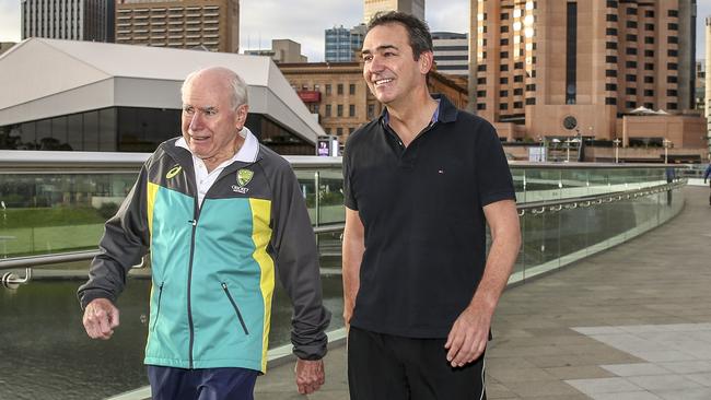 Former PM John Howard and Steven Marshall walk across the Torrens footbridge.