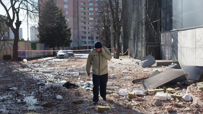 A man surveys damage around a Kyiv apartment building that was hit with a missile yesterday. Picture: Getty Images