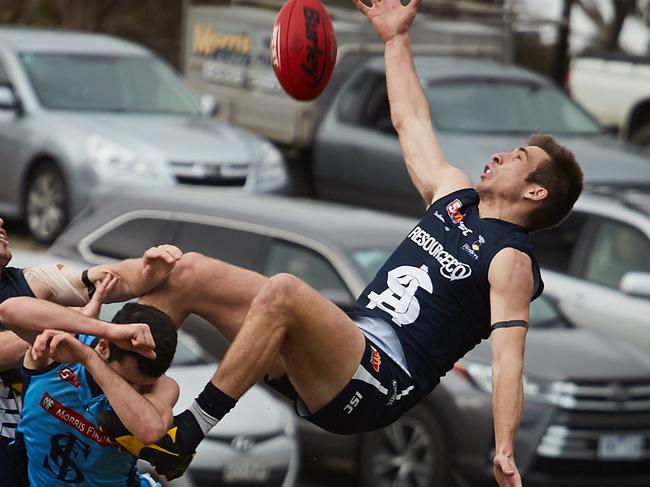 Sturt's Matthew Crocker and South's Joel Cross attempt a mark at Noarlunga Oval, in the match between South Adelaide and Sturt, Sunday, Aug. 12, 2018. (AAP Image/MATT LOXTON)