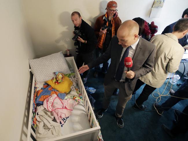 Members of the media crowd into a child's room in an apartment in Redlands, California, shared by San Bernardino shooting rampage suspects Syed Farook and his wife, Tashfeen Malik. Picture: AP