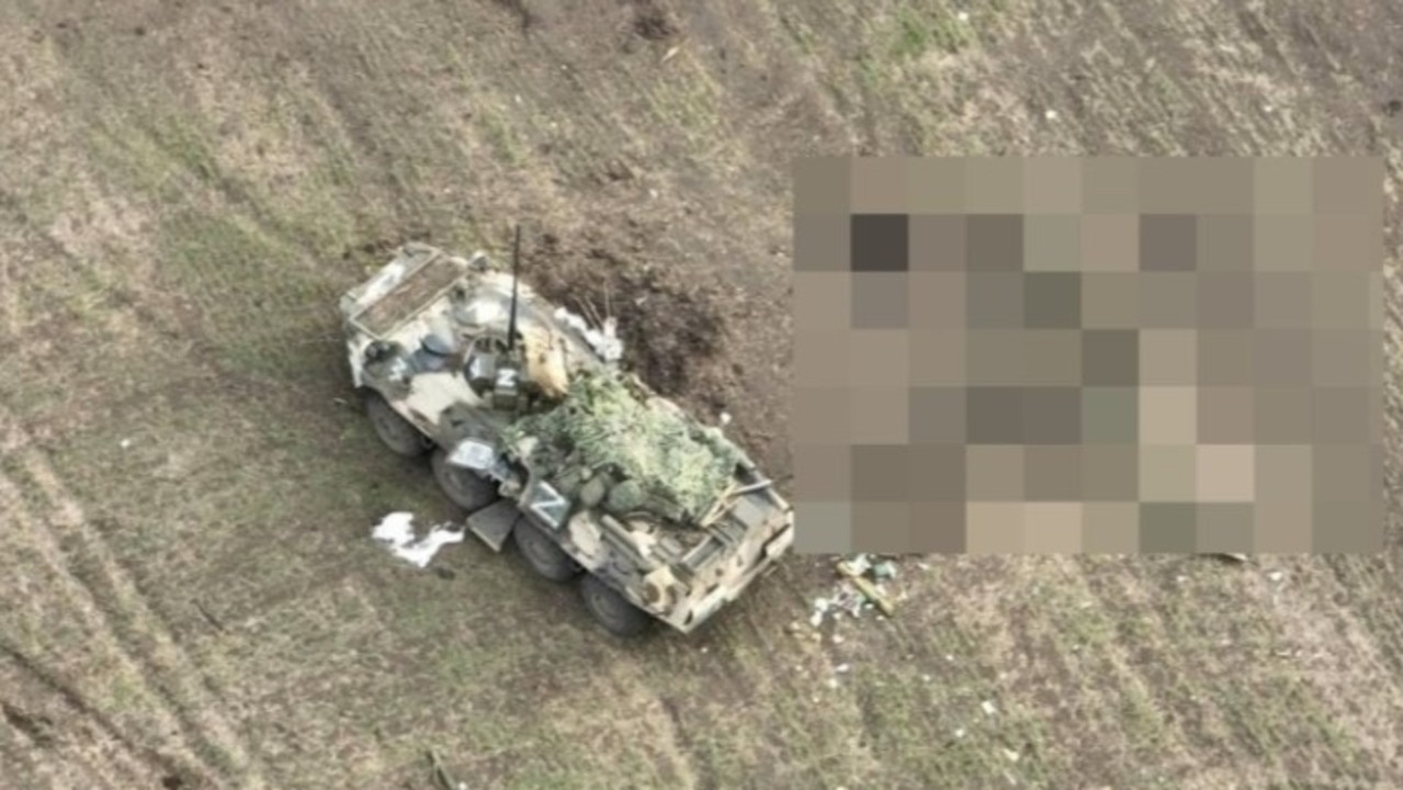 The Russian armoured personnel carrier lies destroyed beside them. Picture: Ukrainian Military.