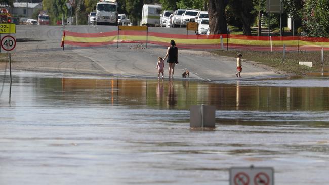 Residents on the north side of Moree look at the falling waters. Picture: John Grainger