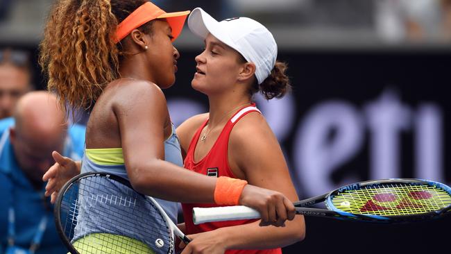 Naomi Osaka is congratulated by Ash Barty.