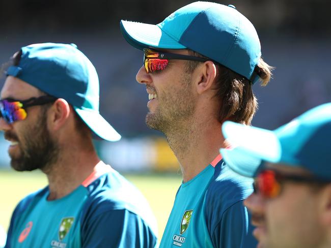 PERTH, AUSTRALIA - FEBRUARY 13: Mitch Marsh of Australia looks on as Marcus Stoinis presents Xavier Bartlett his cap during game three of the Men's T20 International series between Australia and West Indies at Optus Stadium on February 13, 2024 in Perth, Australia. (Photo by Paul Kane/Getty Images)