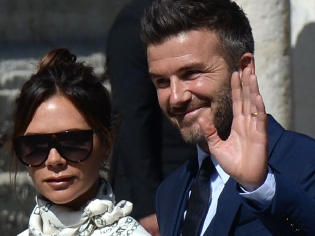 Former Real Madrid midfielder David Beckham (L) and his wife Victoria Bekcham  arrive at the Cathedral of Seville on June 15, 2019 to attend the wedding ceremony of Real Madrid's Spanish football player Sergio Ramos and Pilar Rubio. (Photo by CRISTINA QUICLER / AFP)