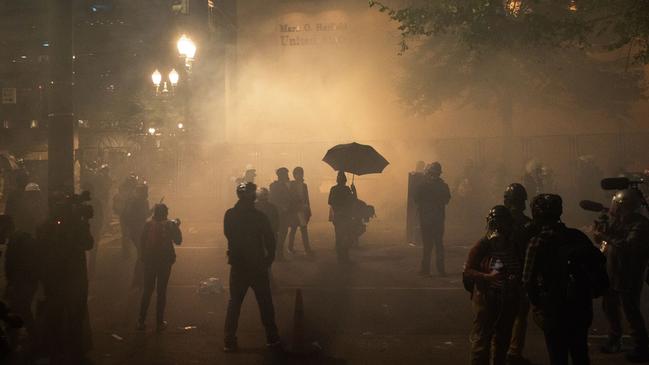 Protesters are surrounded by tear gas near the Mark O. Hatfield federal courthouse in downtown Portland.