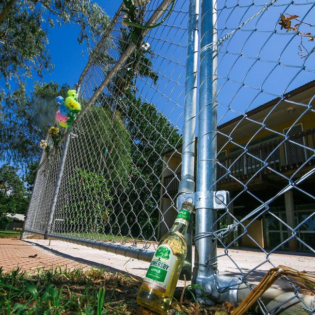 Floral tributes and cider at the scene of an alleged murder in Driver. Picture: Glenn Campbell