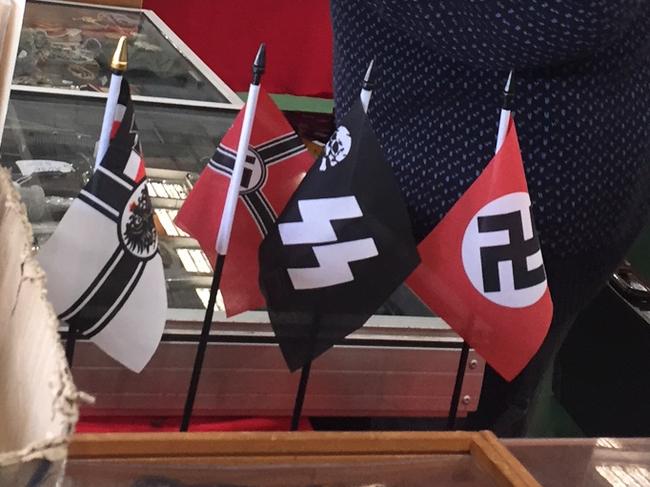 Nazi Paraphernalia at the 89th Melbourne Arms and Militaria Fair in Altona North. A lot of Nazi replica items, cheap Nazi flags, stickers and pins for sale. Couple of huge Nazi flags hanging up.