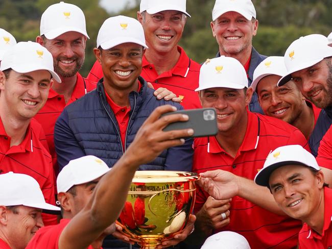 Playing captain Woods and his teammates celebrate their triumph.