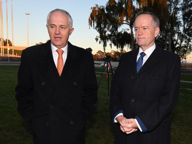 Australian Prime Mimister Malcolm Turnbull (left) speaks to Australian Opposition Leader Bill Shorten as they arrive for early morning TV interviews outside Parliament House in Canberra, Wednesday, May 10, 2017. Treasurer Morrison yesterday delivered his second budget. (AAP Image/Lukas Coch) NO ARCHIVING