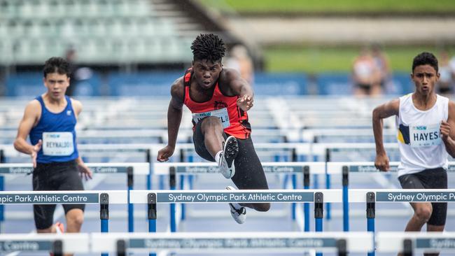 Andres Hampel from Artarmon is a study in determination at the men’s U18 hurdles.