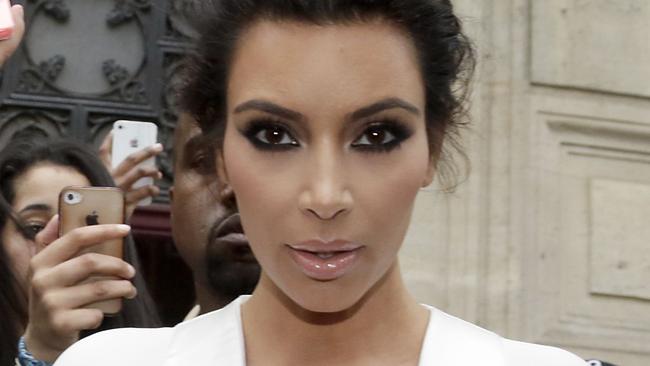 American reality TV star Kim Kardashian leaves her residence in Paris on May 23, 2014, ahead of their wedding. American singer Kanye West and his bride-to-be Kim Kardashian lunched on May 23 at a French chateau owned by iconic designer Valentino, kicking off a marathon celebration expected to culminate in the wedding of the year. AFP PHOTO / KENZO TRIBOUILLARD