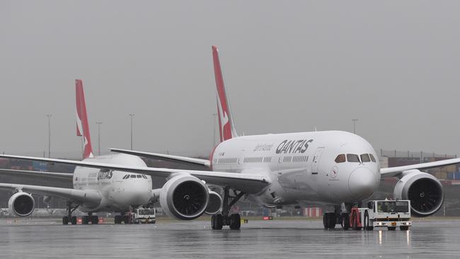 The new QANTAS Boeing 787 Dreamliner aircraft is followed by an A380 Airbus as it arrives on its first flight into Sydney. (AAP Image/Dean Lewins)