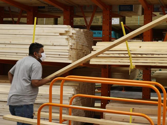 DORAL, FLORIDA - MAY 27: Enrique Matamoros shops for lumber at a Home Depot store on May 27, 2021 in Doral, Florida. According to the National Association of Home Builders, lumber prices went up 300% last year. Factors driving the price increase are more demand and growing production, labor, and transportation costs.   Joe Raedle/Getty Images/AFP == FOR NEWSPAPERS, INTERNET, TELCOS & TELEVISION USE ONLY ==