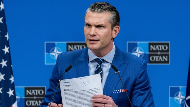 US Secretary of Defence Pete Hegseth shows a sheet of paper with a document containing a summary of President Trump's conversation with Vladimir Putin. Picture: Getty Images.