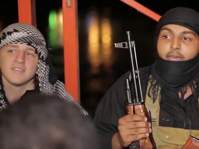 Abdullah Elmir (left) sits with fellow Islamic State fighters in a video released by the group's media wing. Picture: SUPPLIED