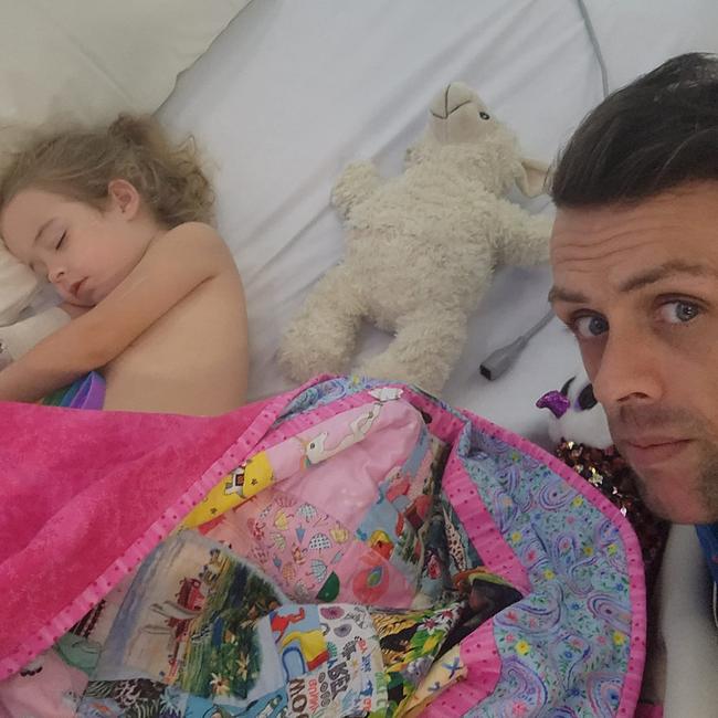 The first image of Nevaeh Austin recovering at Queensland Children's Hospital, watched over by father Shane